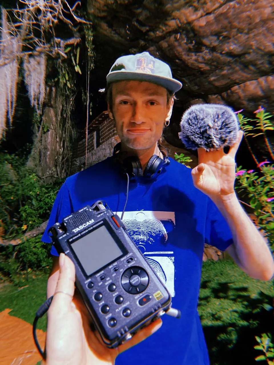 Constantin John holding a TASCAM field recorder and a windshield microphone